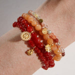 A beautiful collection of Ganesha Hindu God, Overcoming Obstacles Carnelian Gemstone Bracelets stacked together, showcasing vibrant carnelian beads that symbolize confidence and strength. This spiritual jewelry acts as a meaningful talisman for meditation and protection, perfect for yoga and personal manifestation.
