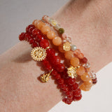 Stylish stacking of the Rooted in Strength Lotus Carnelian Gemstone Bracelet with other gemstone bracelets, designed for spiritual practices and as a talisman for protection and manifestation.