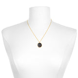 A Scorpio Zodiac Necklace displayed on a mannequin, showcasing its 18kt gold plate and gunmetal over brass design. This spiritual jewelry serves as an amulet for manifestation and protection, making it a perfect meditation gift for those interested in yoga and meaningful symbolism.