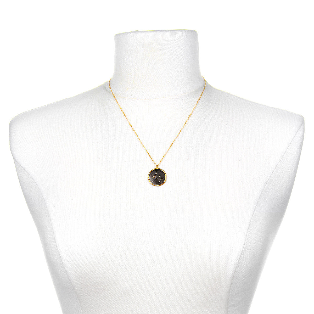 Gemini Zodiac Necklace displayed on a mannequin, highlighting its beautiful gold chain and unique pendant; a perfect representation of zodiac-inspired spiritual jewelry for personal growth and manifestation.