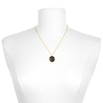 The Capricorn Zodiac Necklace displayed on a mannequin, highlighting its delicate chain and pendant. This symbolic jewelry serves as a protective amulet for meditation, bringing forth the energies of the zodiac in a meaningful way.